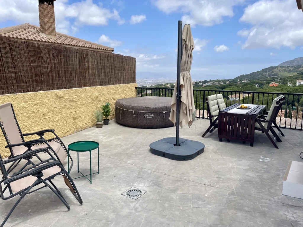 Terraza con jacuzzi y mesa.